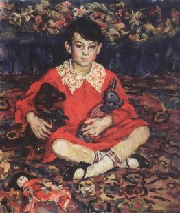 Ritratto di ragazza seduta su un tappeto colorato con i giocatto